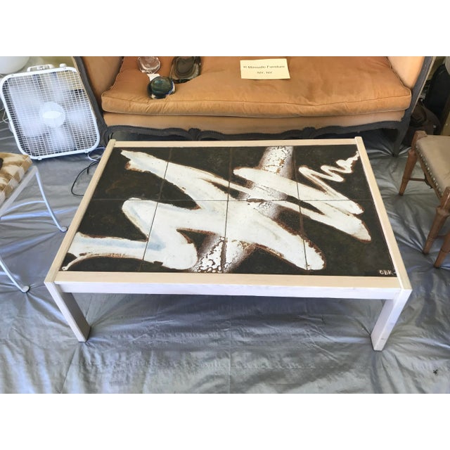 Beautifully raku glazed tile top table signed by artist circa 1960’s. Very little wear. Top done from 6 separate tiles....