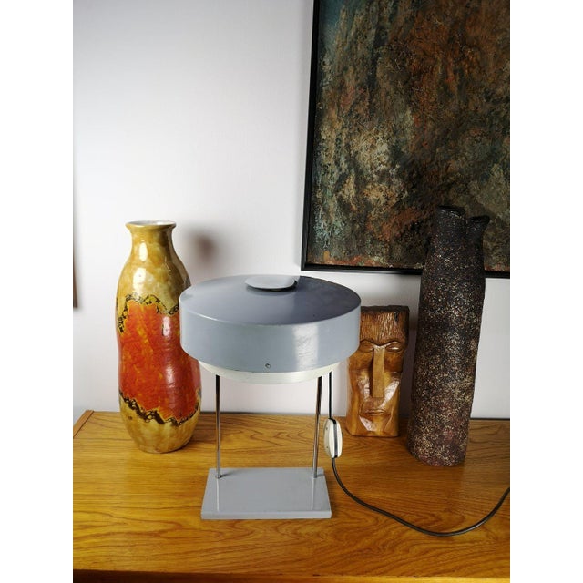 Vintage German table lamp from the 1960s. Gray painted metal plates, chrome-plated stick on a stand. Available in good...