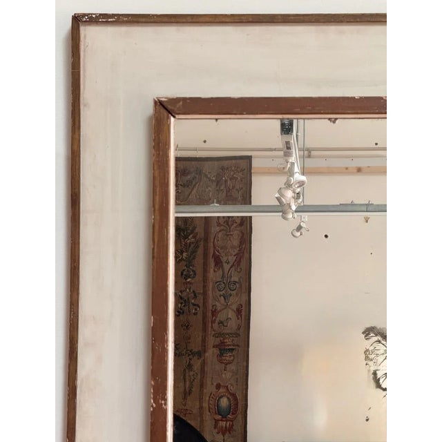 Large Italian mirror, mainly 19th C. The gilt exterior frame around a wider muted white frame enclosing a mirror which is...