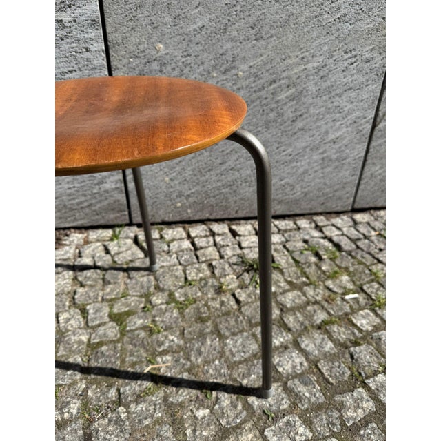 Beautiful mid-century stool with a mahogany seat and steel legs. "Made in Denmark" is engraved on the underside. The stool...
