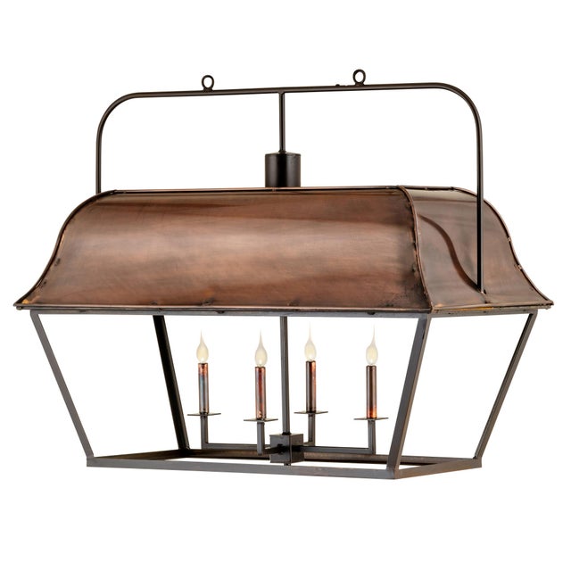 Copper and steel in warm amber and bronze tones, built up into a 32-inch lantern that reads as much like a sculpture as a...
