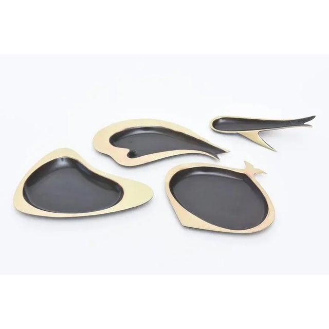 These lovely vintage set of four low bowls, dishes or sculptures definitely have a fish motiff. They are by Karl...