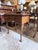 A distinguished early 20th century Queen Anne lowboy showcasing beautifully figured burl walnut veneers and graceful...