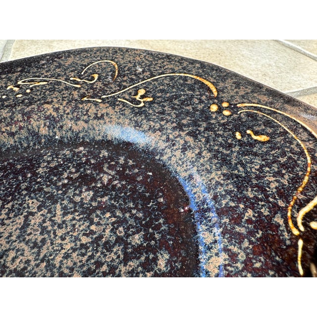 A handcrafted and signed bowl from the workshop of Helma Klett (1908-1996), finished in a warm, rustic brown glaze with...