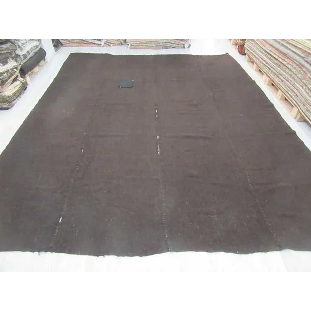 Dark brown vintage goat hair kilim rug from Afyon region of Turkey. This tente kilim rug handwoven in Afyon region of...