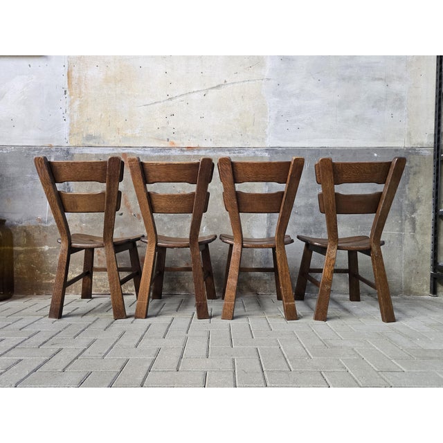 This very sturdy dining room set of four solid oak chairs is in a good condition. The chairs are beautifully designed with...