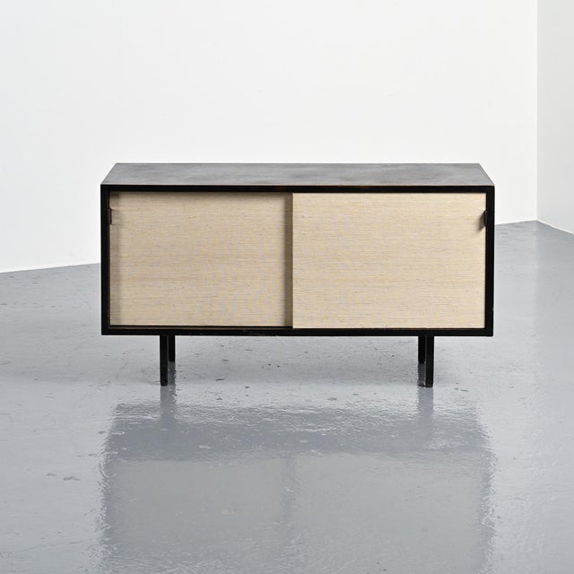 A design classic by Florence Knoll, this sideboard features two raffia-covered doors for an elegant touch. The rectangular...