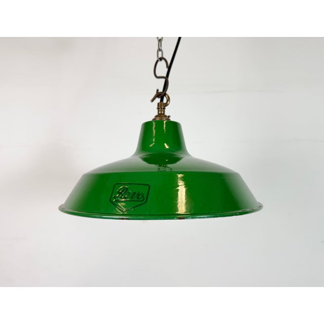 Industrial green enamel pendant light made by Revo in United Kingdom during the 1950s. White enamel inside the shade....