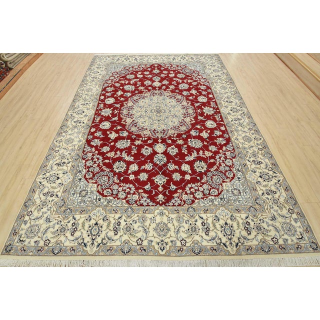 An authentic vintage traditional Nain rug hand-knotted with fine wool and natural dyes. This intricately woven rug...