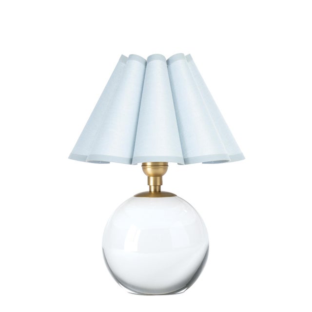 The Giorgio Mini Table Lamp provides a soft, inviting glow through its mist blue scalloped shade, making it a perfect...