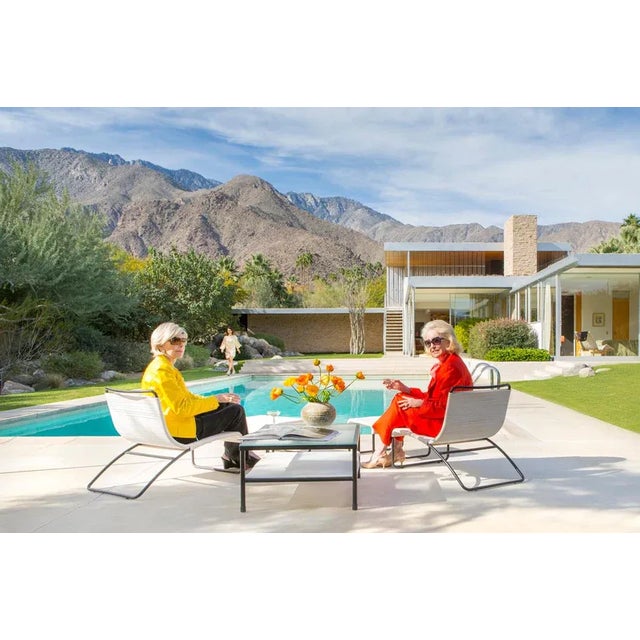 In celebration of the Slim Aarons Poolside Gossip photo, this photo shot 45 years to the day later, features the original...