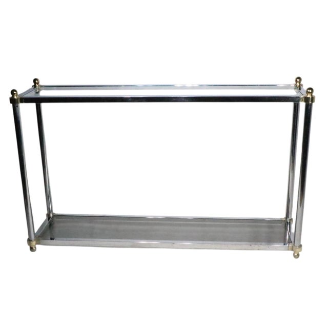 Chic and stylish Hollywood Regency style console table constructed of a chrome plated frame with brass plated joinery,...