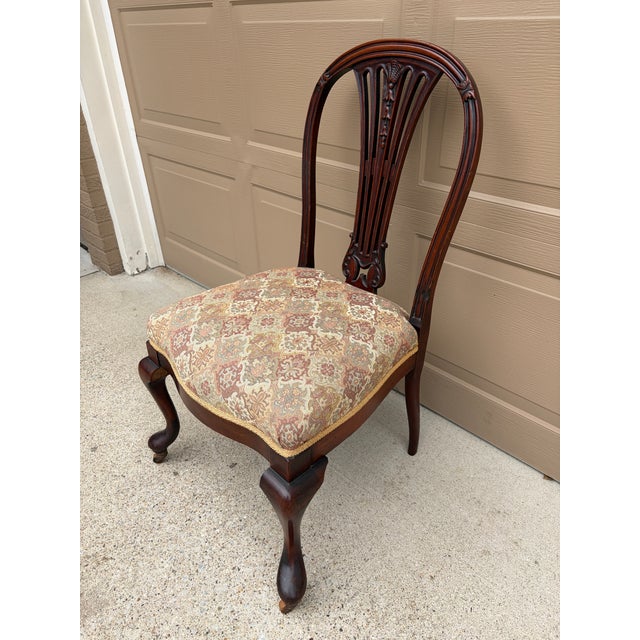 A beautiful antique Georgian style mahogany side chair upholstered in a classic tapestry fabric. The hand carved details...