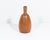 A turned wood vase signed "Kinzer." This vase features an elongated and bulbous shape, with a narrow opening. It is signed...