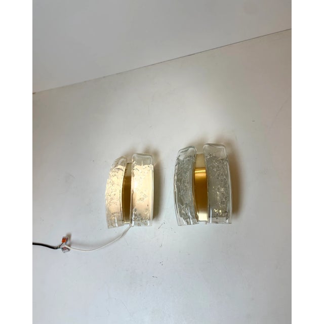Pair of high-end wall lights made of tubular melted glass suspended on a brass base. Designed by the iconic firm doria in...