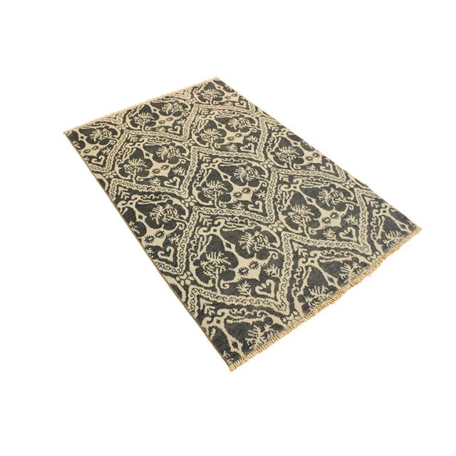 This elegant hand knotted rug features a modern fusion of beauty, with its interlocking geometric and minimalist pattern....