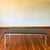 This Florence Knoll style coffee table features a minimalist chrome frame and a smoked glass top. Glass is in good shape...