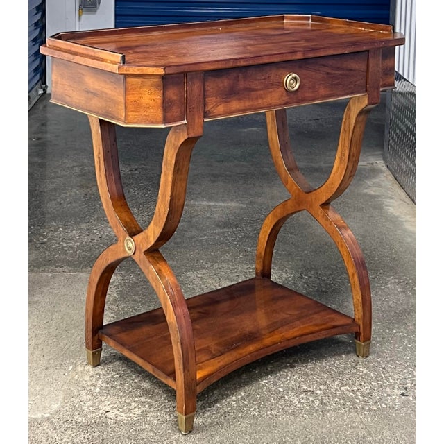 Gorgeous European influenced neoclassical side table with drawer. Crafted in solid maple with thoughtful factory...