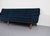 A long low proflie sofa in aged original navy knit upholstery. Minimalist cushions. Comfortably seats four persons. Built...