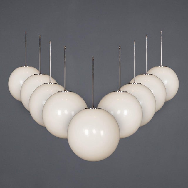 A vintage 20th century set of nine large white moulded polymer globe lights with white metal fittings. Simple in design,...