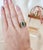 This is a vintage gold ring featuring an elongated emerald gemstone and round brilliant diamonds. Circa 1960's Details:...