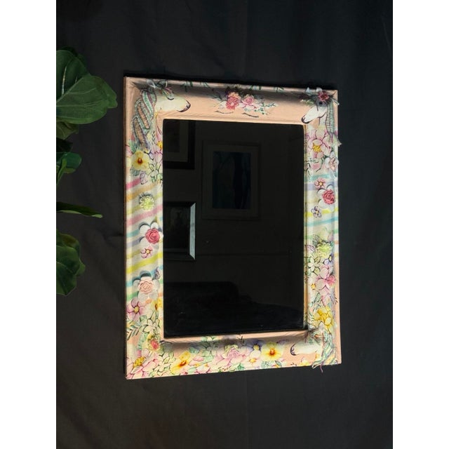 Rectangular wall mirror with a fabric-wrapped frame in a unicorn and floral motif, with pastel stripes in blush pink,...