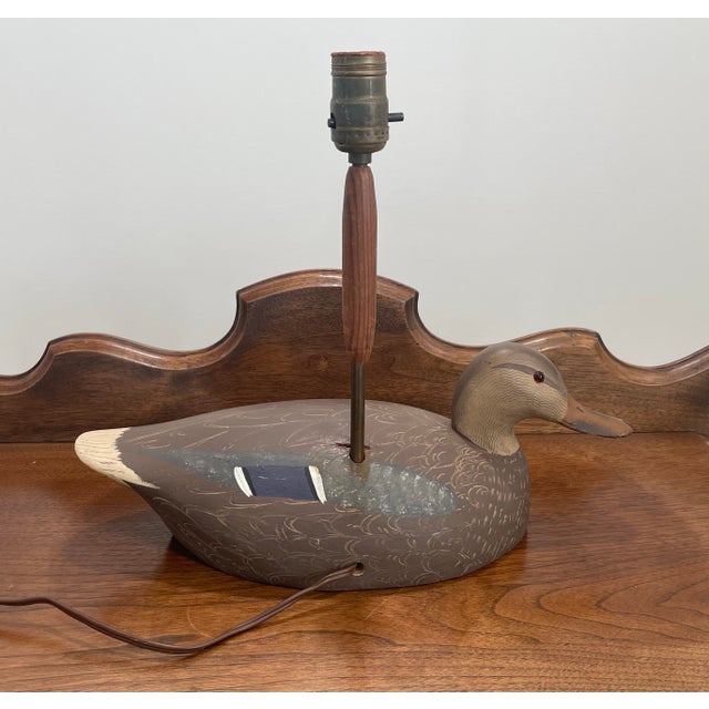 A charming American mid-century hand carved and polychrome painted wooden duck decoy lamp. Exceptionally executed, hand...