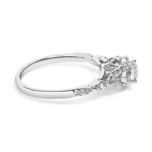 Imbued with timeless elegance, this vintage-style engagement ring is a true symbol of sustainable luxury. Exquisitely...