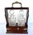 Imported from England. Late 1800s tantalus set featuring two square cut crystal decanters housed in a lockable oak frame....