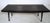 Mid-Century Modern black lacquered slat bench featuring tapered legs. This bench can also be used as a coffee table, would...