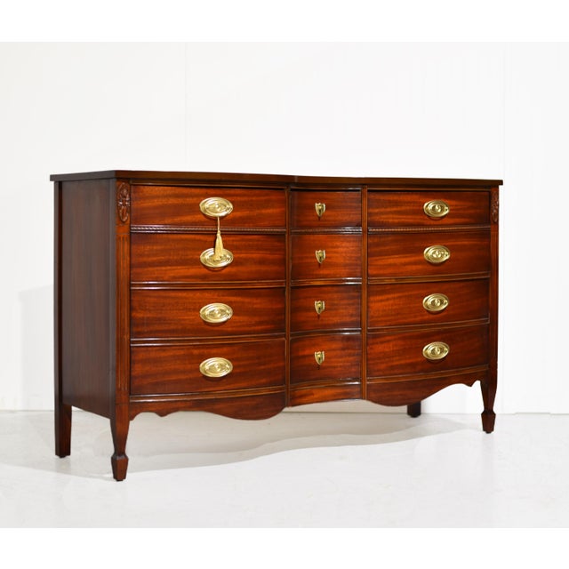 Elegant curves and timeless proportions define this mid century Federal-style triple dresser by Dixie. Crafted in rich...