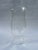 A single round clear and colorless blown glass baluster form candle hurricane shade.