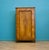 Biedermeier style single wardrobe in walnut veneer, dating to around the 1930s. Features a shaped moulded door with...