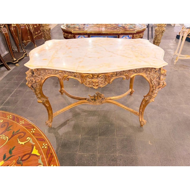 Enhance your home decor with this exquisite Vintage Rococo Cherub Marble Top Center Table. Featuring a stunning white...
