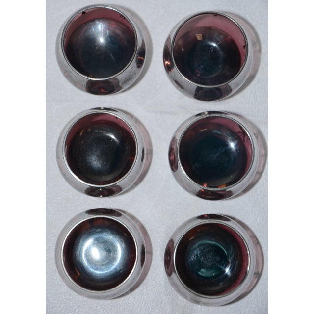 Draped garlands of flowers in surround each of these dainty snifters. The aged patina on the amethyst glass is beautiful!...