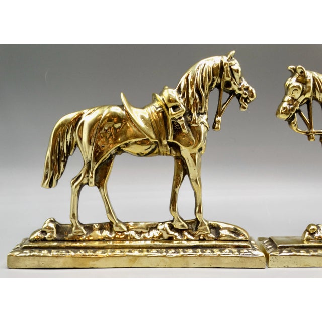 A lovely quality pair of 19th-Century English cast solid bright gilt brass mantel horses circa 1890. These handsome...