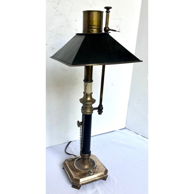 This vintage Chapman bouillotte table lamp features solid brass construction with a black tole shade. It has an adjustable...