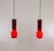 A pair of hand-blown red no. 011.11 glass pendants designed by Massimo Vignelli at the start of his impressive career in...