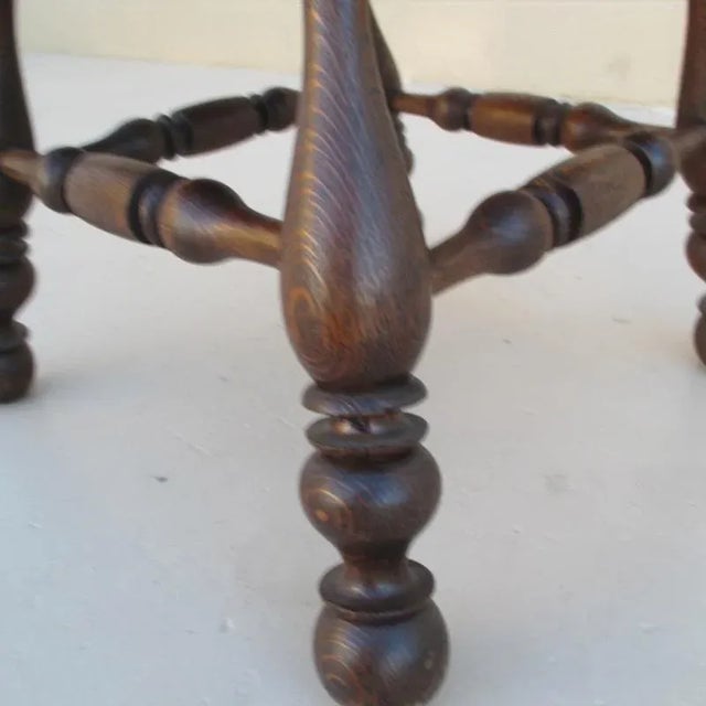 English antique pub armchair. This chair is oak with turned legs, scroll arms and a detailed carving featuring a pub...