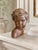 A beautifully detailed late 19th-century French decorative bust of a child, crafted from solid earthenware with a warm...
