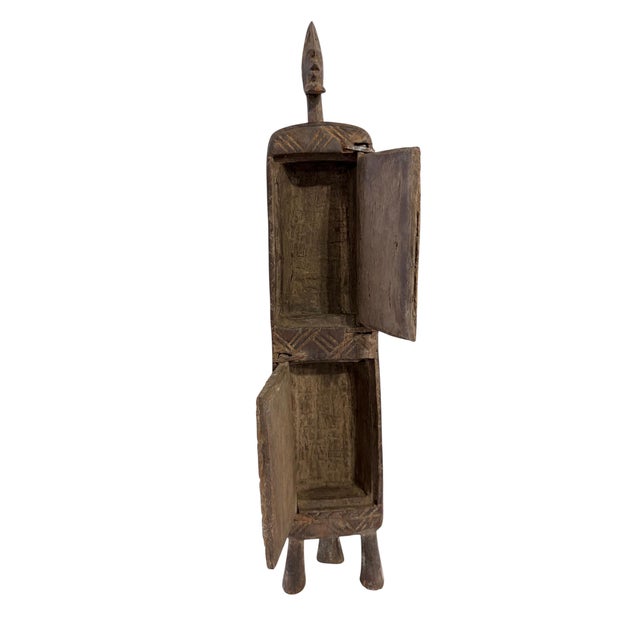 Superb and unique hand-carved wooden box from the Dogon tribe of Mali, featuring a double-door design traditionally used...