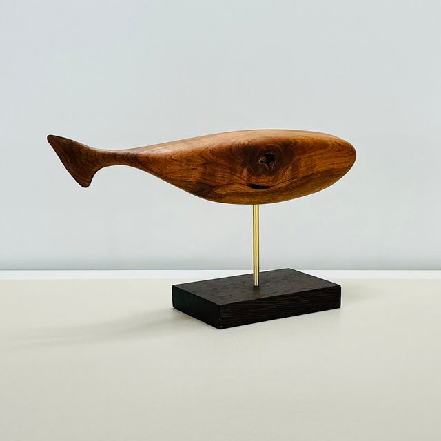 Contemporary Coastal Whale sculpted from solid Reclaimed Cherry Hardwood floating over a stand of Wenge via a Brass rod....