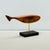 Contemporary Coastal Whale sculpted from solid Reclaimed Cherry Hardwood floating over a stand of Wenge via a Brass rod....