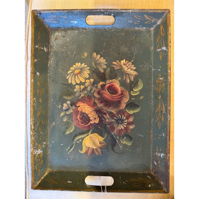 This is an antique metal tin toleware tray. It depicts beautiful florals with a rustic look. It is fabulous