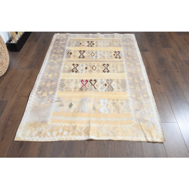 Vintage Hand-Knotted runner rug is a semi-antique vintage area rug. The '70s Eastern region of Anatolia's unique rug is...