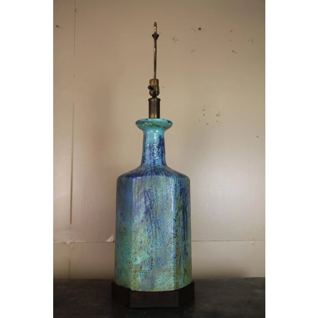Large Italian pottery lamp with walnut base. Colors are great and with the unique walnut base, this lamp makes a statement.