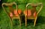 A pair of yellow, hand-painted side chairs in the Chinoiserie or Japanned style, featuring curved splat backs with pagoda...