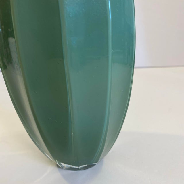 This vintage green fluted glass bud vase is the perfect combination of minimalist chic and sophisticated elegance. Its...