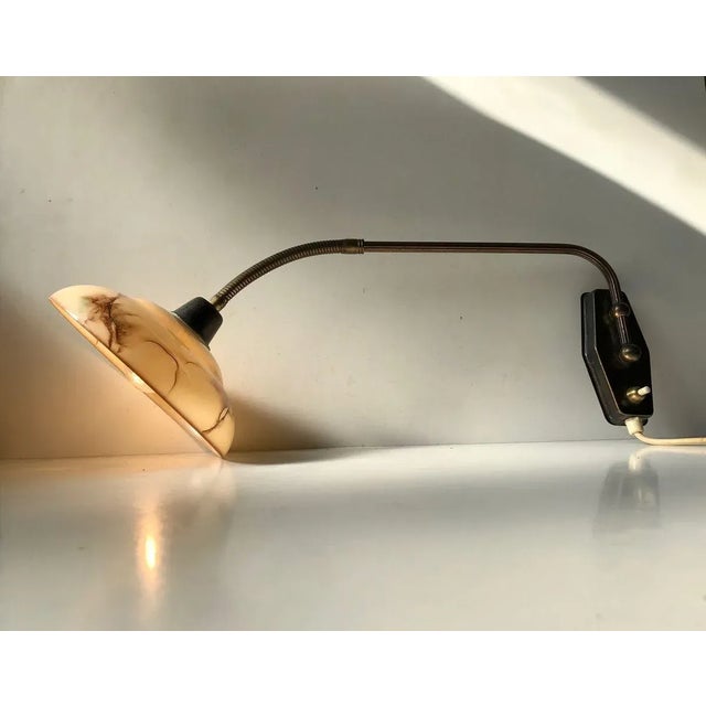 Fully adjustable wall lamp designed and manufactured by Th. Valentiner in Copenhagen, Denmark during the 1950s. It...