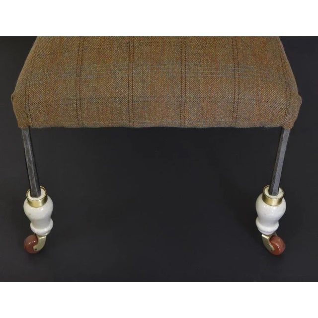 A very unusual British antique steel framed side chair. With scrolled horn-type ends and turned painted wooden legs, it...